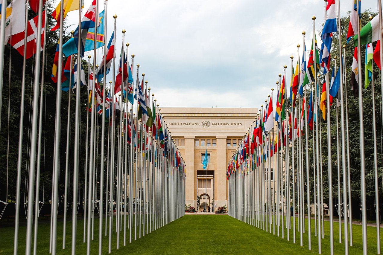 Bandeiras de diversos países em frente à entrada da sede da ONU em Genebra.